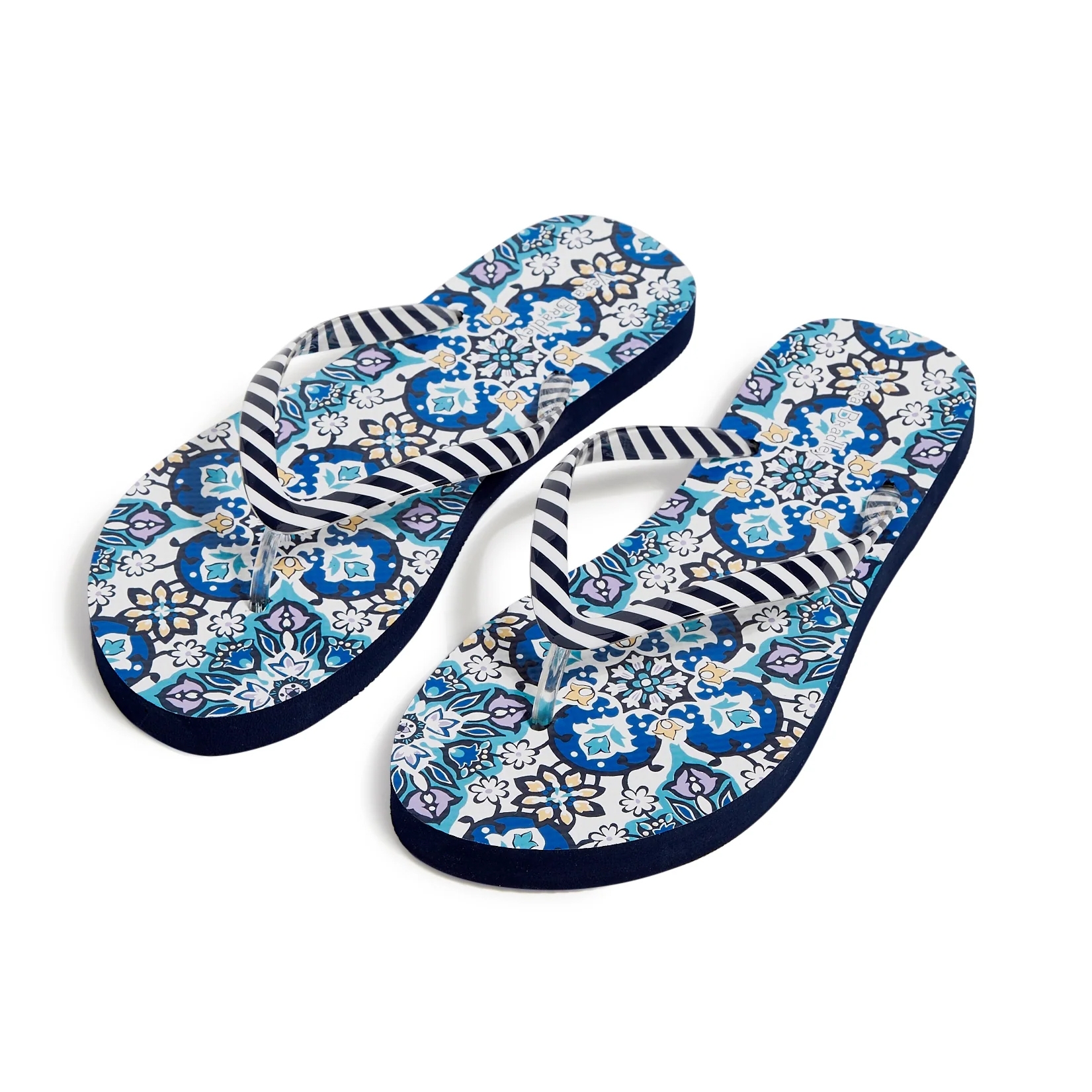 A pair of flip-flops with striped straps and a blue floral print on the soles.