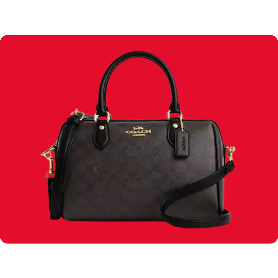 A black Coach handbag with a dome shape, featuring two top handles, gold hardware, and a detachable shoulder strap.