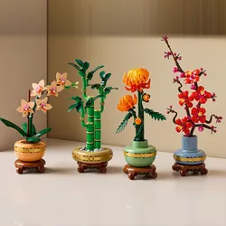 Four LEGO botanical sets featuring a variety of plants: an orchid, bamboo, an orange chrysanthemum, and cherry blossoms, each displayed in decorative pots.