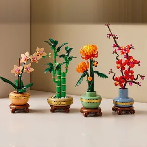Four LEGO botanical sets featuring a variety of plants: an orchid, bamboo, an orange chrysanthemum, and cherry blossoms, each displayed in decorative pots.
