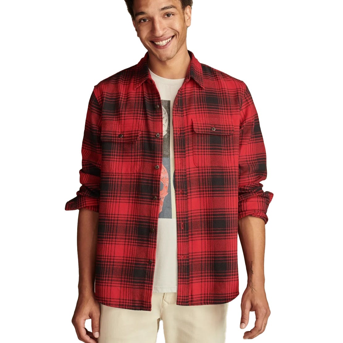 Red and black plaid flannel shirt over a graphic T-shirt, worn by a person in light-colored pants.