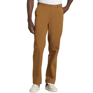A person is wearing brown pants paired with white sneakers.