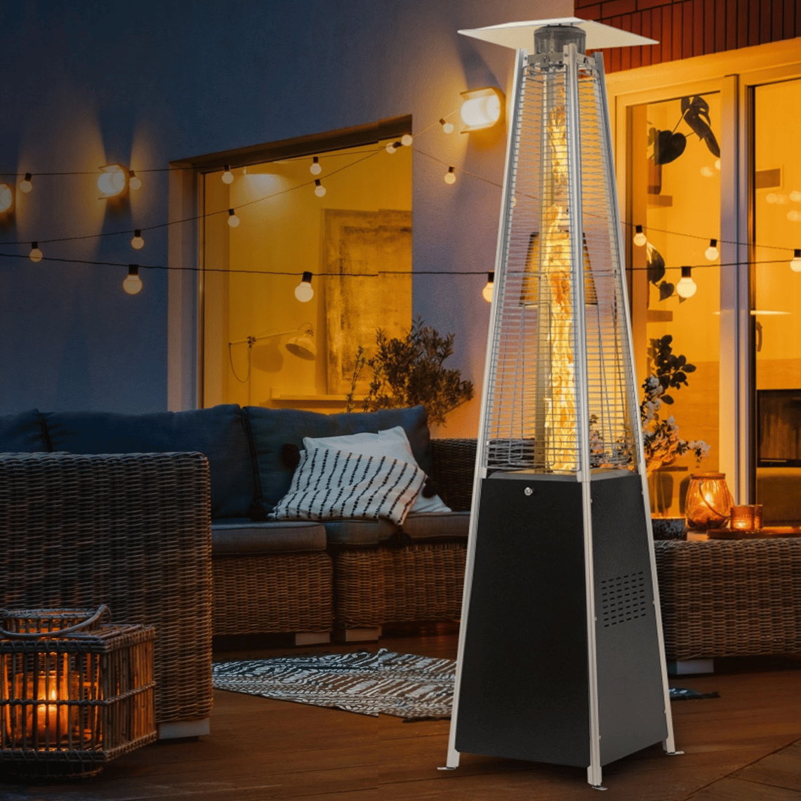 Outdoor patio heater with a pyramid-shaped frame, set in a cozy patio area featuring wicker furniture, string lights, and soft cushions.