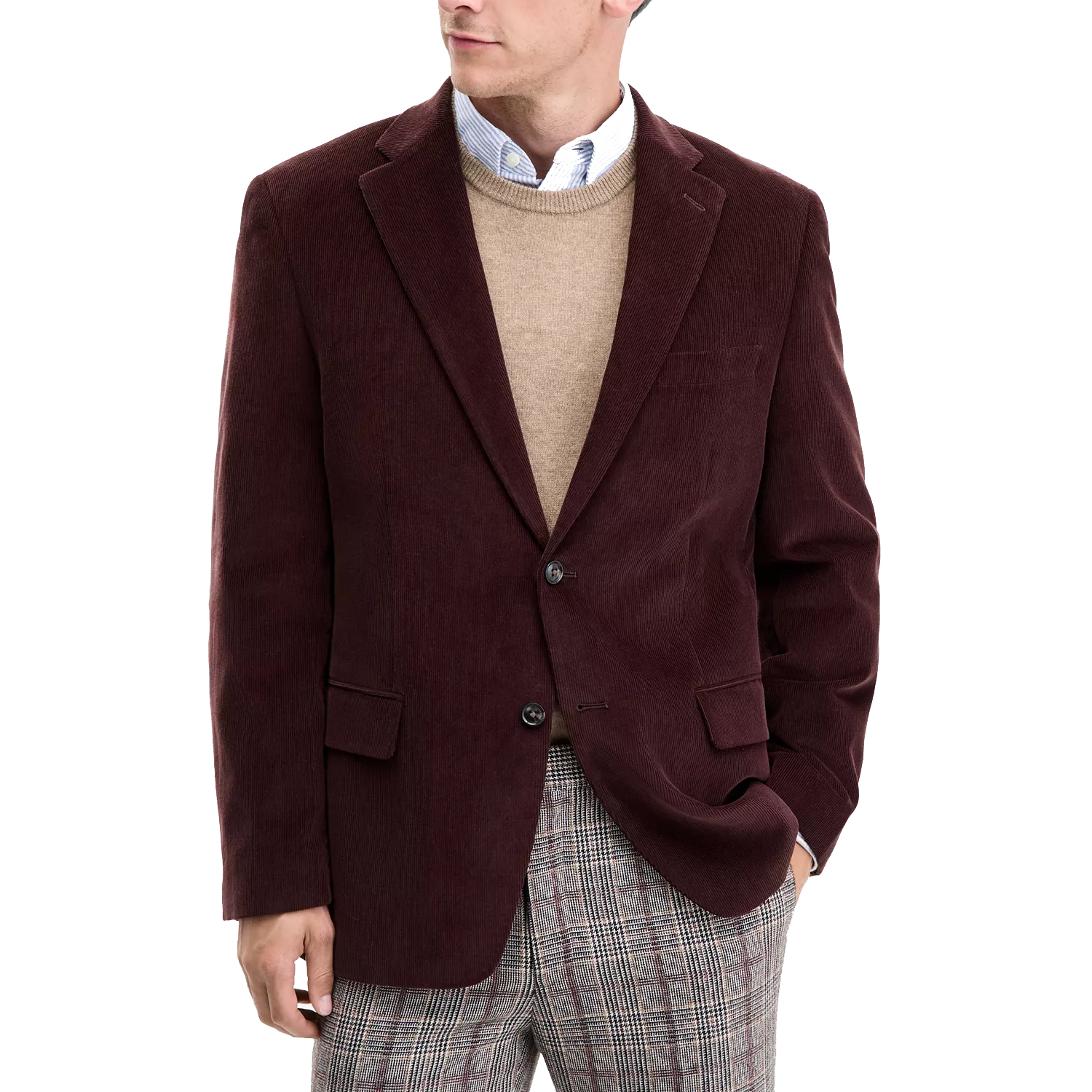 A burgundy corduroy blazer is worn over a beige sweater with a blue button-up shirt and plaid trousers.