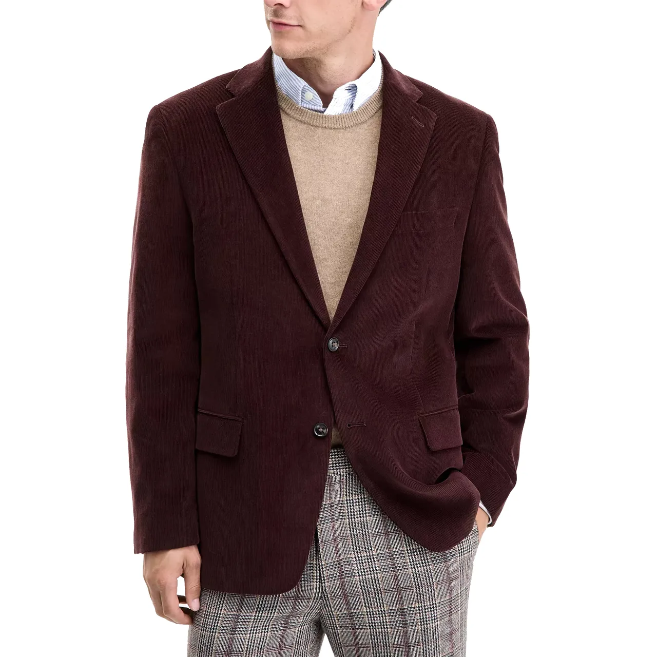 A burgundy corduroy blazer is worn over a beige sweater with a blue button-up shirt and plaid trousers.
