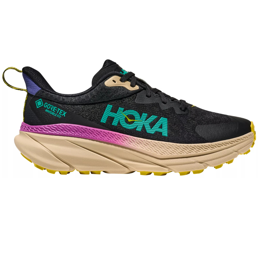 Hoka shoe with GORE-TEX Invisible Fit technology, featuring a black upper with teal logo, purple accent, beige midsole, and yellow outsole.