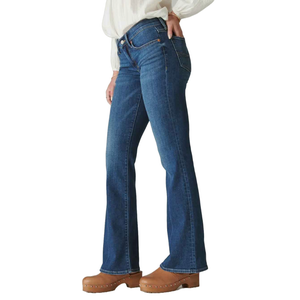 Mid-Rise Sweet Flare Jeans by Lucky Brand feature a classic blue wash, mid-rise waist, and flared legs. They are paired with brown clogs and a light blouse.