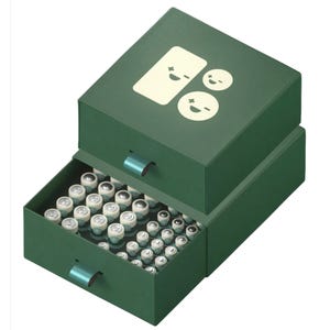 A green storage box with handles, featuring a design of smiling battery icons, contains various battery sizes neatly organized in two drawers.