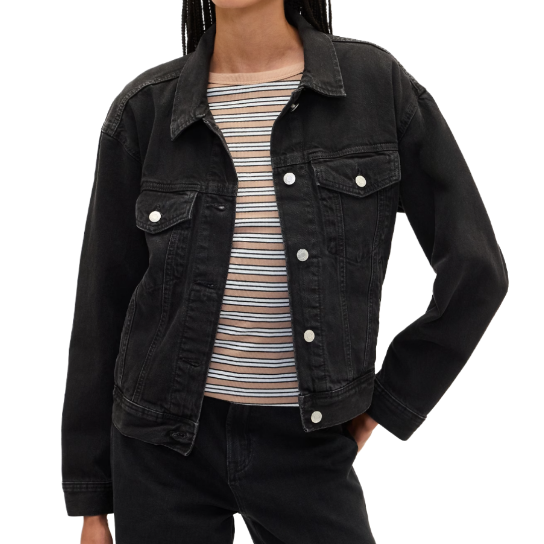Black denim jacket over a striped shirt, paired with black jeans.