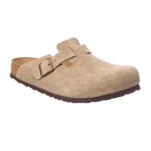 Tan suede clog with an adjustable buckle strap and a cork footbed, featuring a rubber sole.