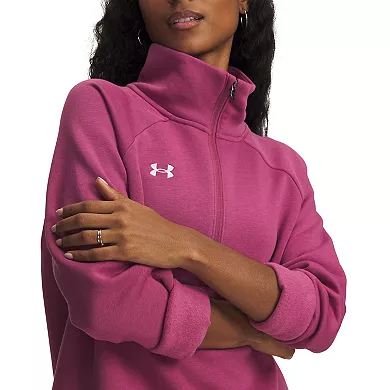 A person is wearing a pink Under Armour half-zip pullover with rolled-up sleeves, featuring the brand's logo on the chest.