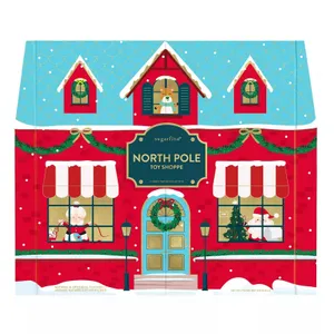 Sugarfina North Pole Toy Shoppe box features Christmas-themed artwork with snow, Santa, and holiday decorations. It is a candy tasting collection with festive design elements like wreaths and garlands.