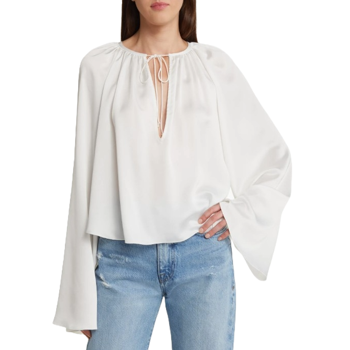 White, long-sleeve blouse with a gathered neckline and tie detail. Styled with light blue jeans.