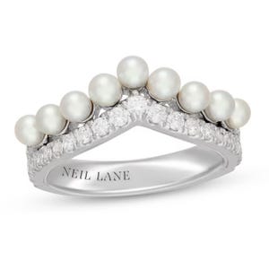 White gold ring with a row of pearls on top and encrusted with small diamonds, featuring the engraving \“NEIL LANE\“ inside the band.