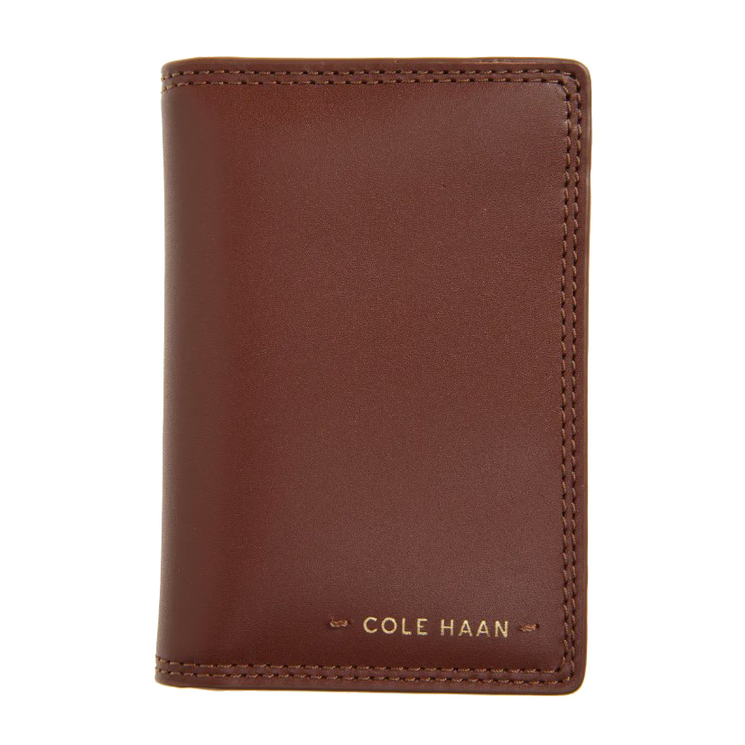 This is a Cole Haan men's bifold wallet in brown leather with stitched edges and a stamped logo on the front.