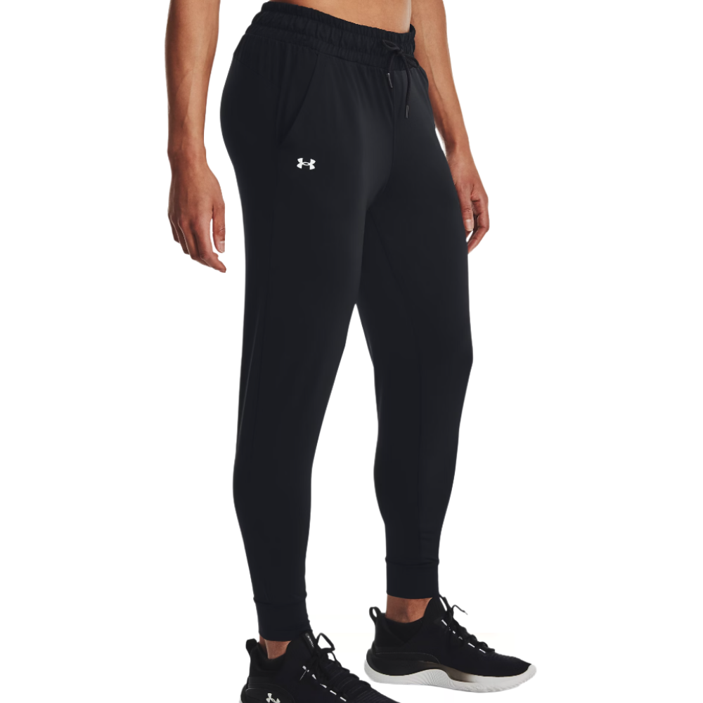 Black Under Armour joggers with an elastic waistband, side pockets, and a logo on the left thigh, paired with black athletic shoes.