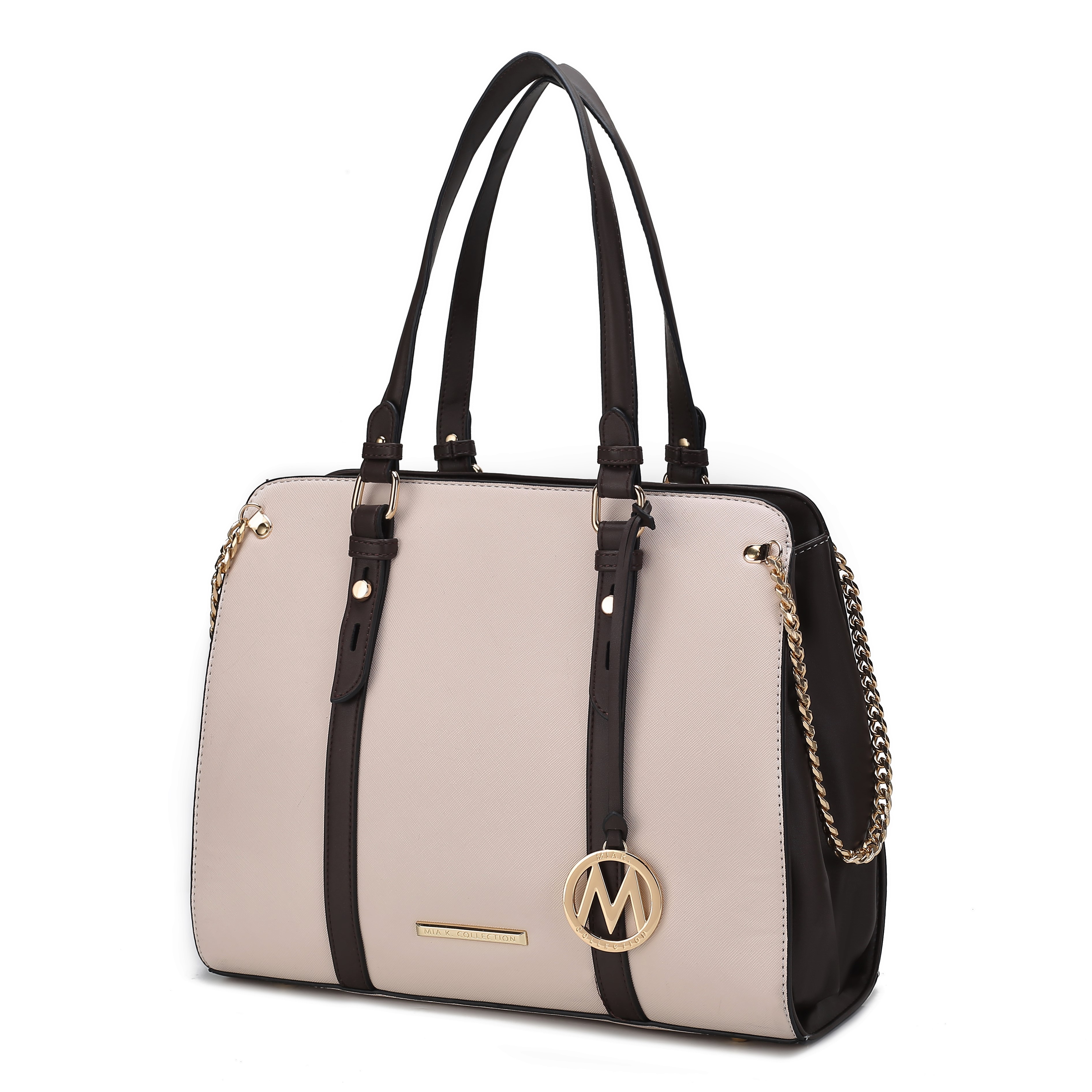A cream and black color-block shoulder bag with gold chain accents, featuring double handles and a dangling circular charm with \“M\“ initial.