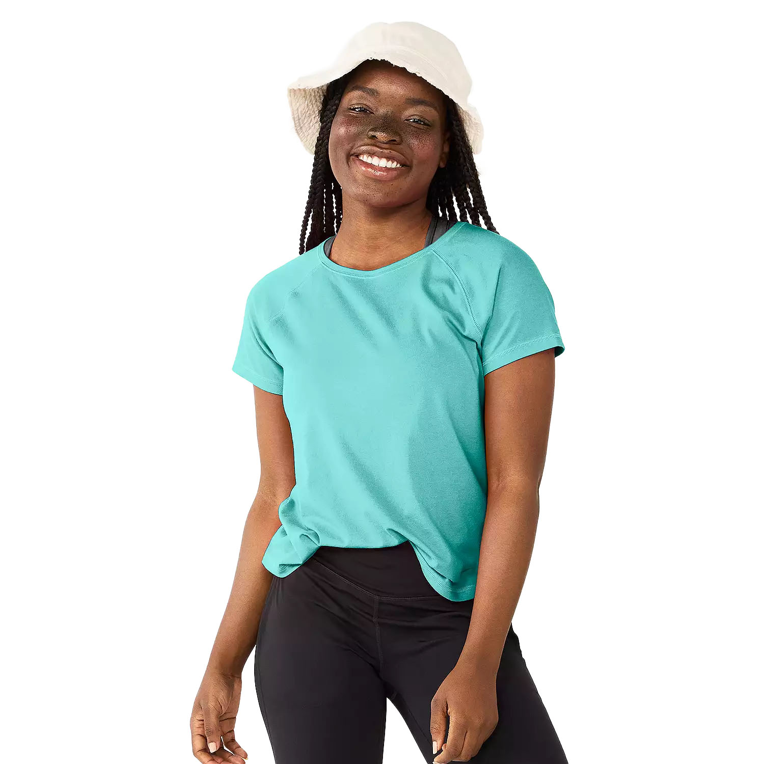 Woman wearing a turquoise T-shirt, black leggings, and a white bucket hat, smiling.