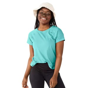 Woman wearing a turquoise T-shirt, black leggings, and a white bucket hat, smiling.