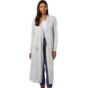 A woman is wearing a light gray, long open-front cardigan paired with a white top and blue pants. The cardigan features pockets and extends to below the knee.