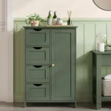 Green bathroom cabinet with three drawers and a door, featuring a potted plant, liquid bottles, and a reed diffuser on top.