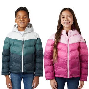 Two children are wearing colorful puffer jackets; one in green tones and the other in pink tones, both with hooded designs.