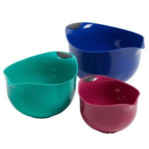 Three Cuisinart mixing bowls in blue, green, and red feature integrated pour spouts and non-slip bases for easy handling. Each bowl is a different size, ideal for various kitchen tasks.