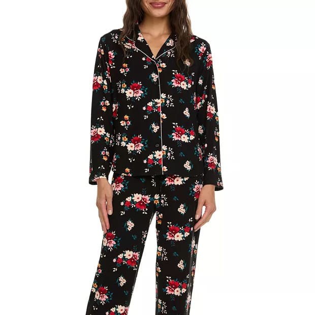 Black 2-piece pajama set with a floral pattern, featuring red, white, and teal flowers. It includes a long-sleeve button-up top and matching pants.