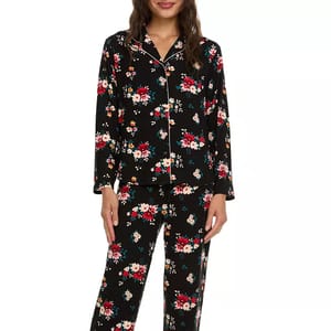Black 2-piece pajama set with a floral pattern, featuring red, white, and teal flowers. It includes a long-sleeve button-up top and matching pants.