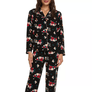 Black 2-piece pajama set with a floral pattern, featuring red, white, and teal flowers. It includes a long-sleeve button-up top and matching pants.
