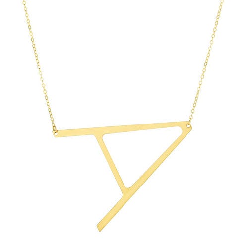 Gold necklace featuring a geometric pendant with an abstract, angular shape on a delicate chain.