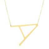 Gold necklace featuring a geometric pendant with an abstract, angular shape on a delicate chain.