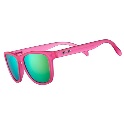 Pink sunglasses with green reflective lenses and the brand name \“goodr\“ on the arm.