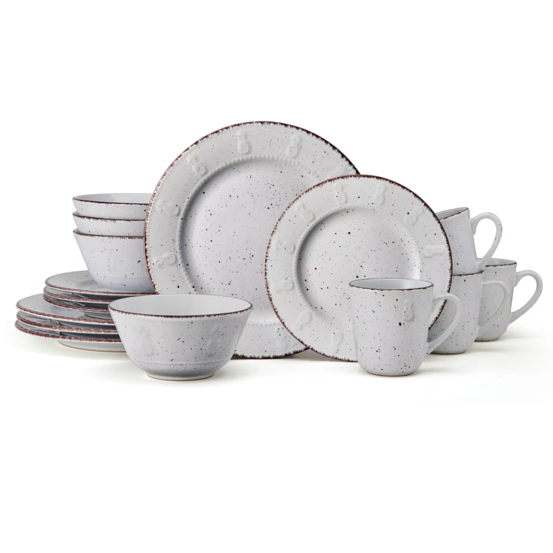 The 16-piece Pfaltzgraff Dinnerware Set includes stoneware in an off-white, speckled pattern with a subtle embossed design. It comprises four each of dinner plates, salad plates, bowls, and mugs, featuring rustic charm suitable for casual dining.