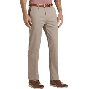 A pair of beige chinos with a brown leather belt and brown leather shoes, worn by a person. The person is also wearing a red shirt.