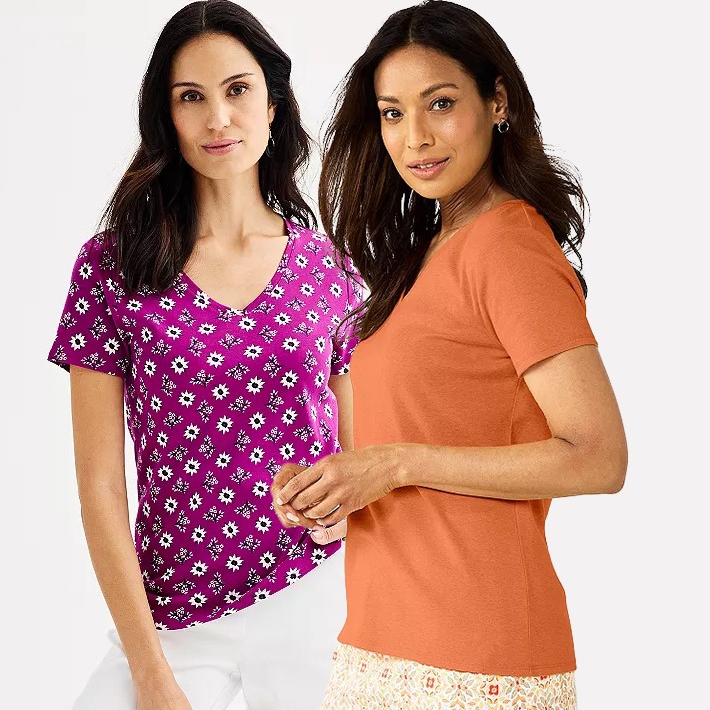 Two women are wearing V-neck T-shirts, one with a purple floral pattern and the other in solid orange.