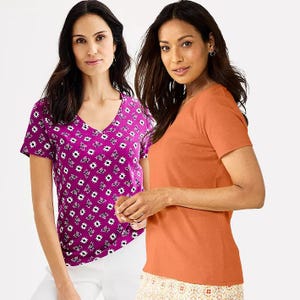 Two women are wearing V-neck T-shirts, one with a purple floral pattern and the other in solid orange.