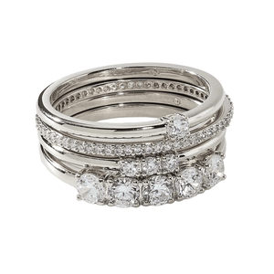 A set of stacked platinum rings featuring multiple rows of diamonds in various settings, offering a luxurious and sparkling design.