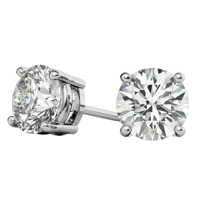 A pair of round diamond stud earrings set in four-prong metal settings, showcasing their brilliance and clarity.
