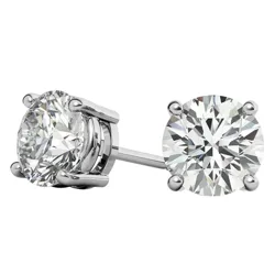 A pair of round diamond stud earrings set in four-prong metal settings, showcasing their brilliance and clarity.