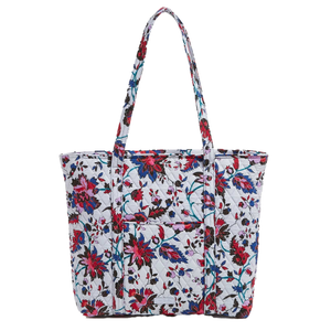 A floral-patterned Vera Bradley tote bag with quilted fabric, featuring multiple exterior pockets and two shoulder straps.
