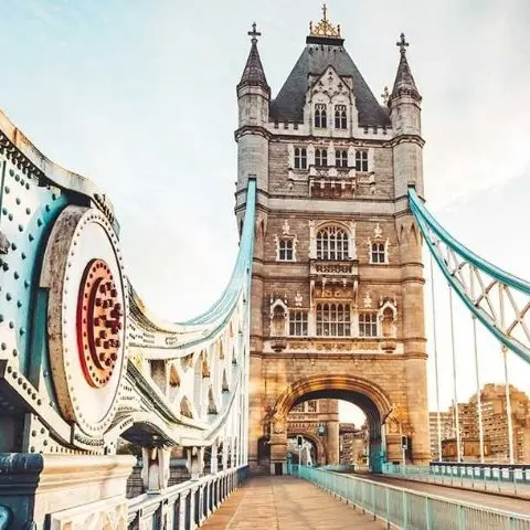 Tower Bridge in London, showcasing its distinctive Victorian Gothic architecture and blue suspension parts.