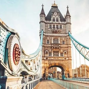 Tower Bridge in London, showcasing its distinctive Victorian Gothic architecture and blue suspension parts.