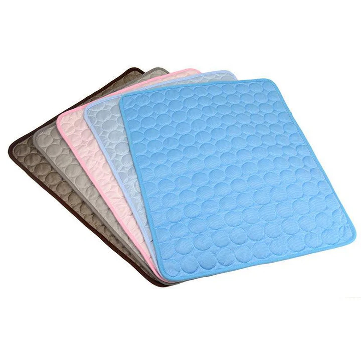 A set of quilted pads in various colors, including blue, pink, grey, and brown, featuring a circular pattern.