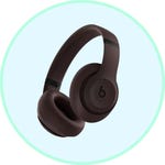 Over-ear wireless headphones with a circular logo on the ear cups, in a dark brown color.