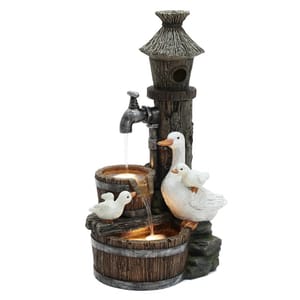 A decorative outdoor fountain featuring a rustic birdhouse with a thatched roof and LED-lit water flowing from a spout into wooden barrels, accompanied by a mother duck and two ducklings.