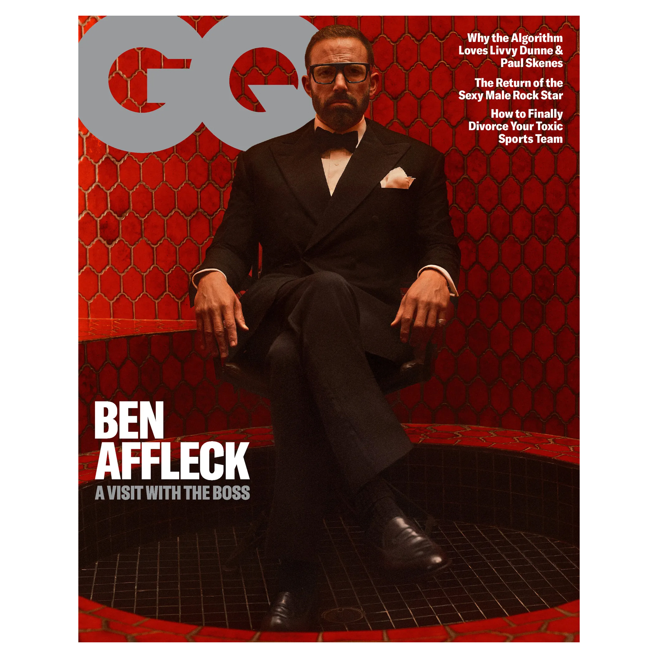 A magazine cover features a man in a suit sitting in a red-tiled room, with bold text reading \“Ben Affleck: A Visit with the Boss\“ and article titles discussing algorithms, rock stars, and sports teams.
