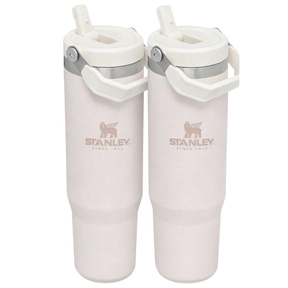 Two light pink Stanley travel mugs with handles and straws, featuring the Stanley logo and \“Since 1913.\“