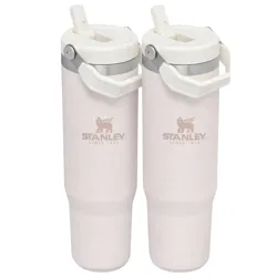 Two light pink Stanley travel mugs with handles and straws, featuring the Stanley logo and \“Since 1913.\“