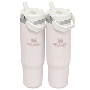 Two light pink Stanley travel mugs with handles and straws, featuring the Stanley logo and \“Since 1913.\“